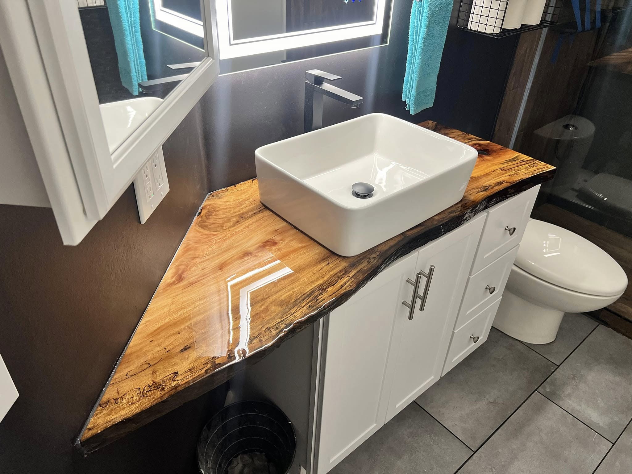 Spalted live-edge bathroom vanity top with clear epoxy fill, installed at a customer's home