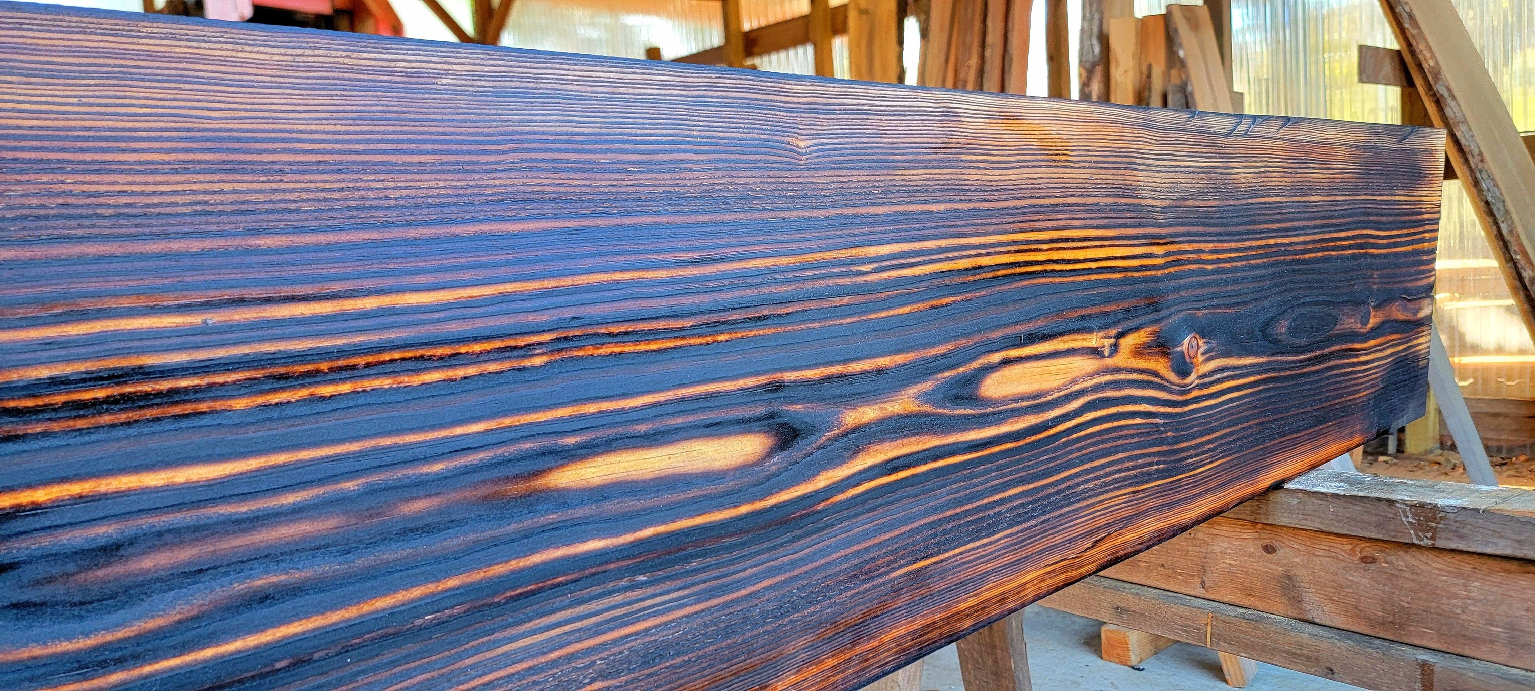 Shou sugi ban charred heart pine beam with deep cathedral grain
