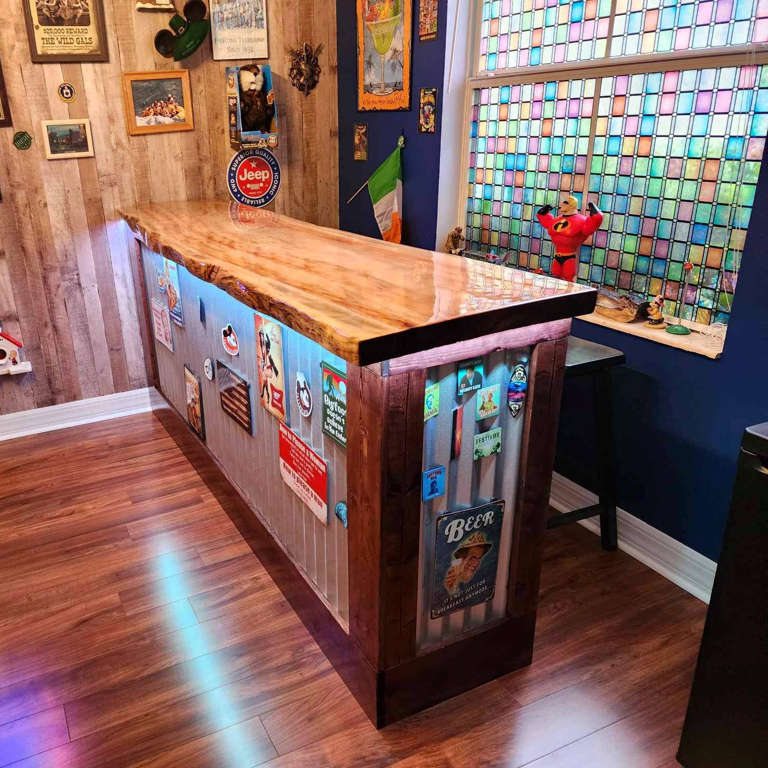 Custom basement bar with butcher-block top, wood-paneled wall