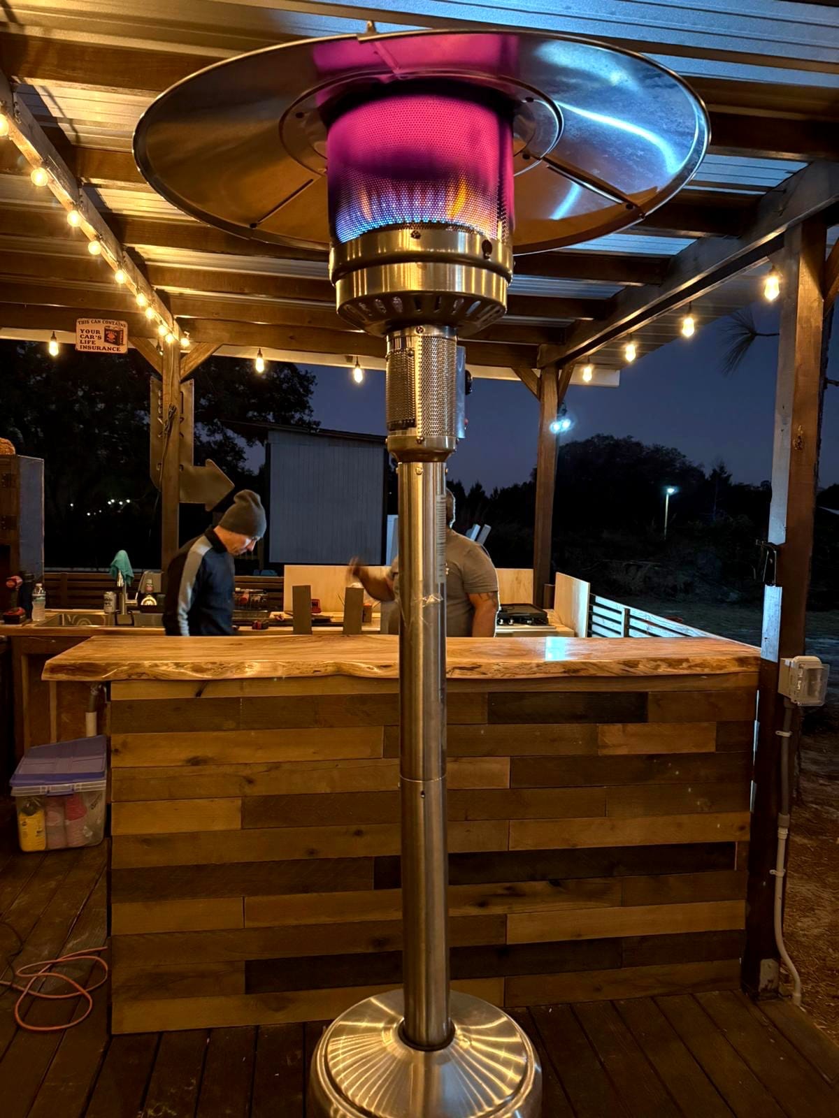 Outdoor live-edge bar top photographed at dusk